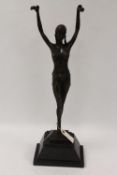 After Demetre H. Chiparus - A bronze figure depicting an Art Deco style lady with her arms raised,