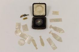 A selection of Chinese mother of pearl counters, together with a German miniature blank-firing