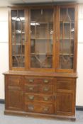 An Edwardian oak bookcase, fitted with four drawers, width 153 cm. CONDITION REPORT: Good condition,