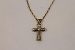 A 9ct gold crucifix pendant on 9ct gold chain. CONDITION REPORT: Good condition.