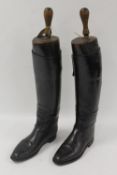 A pair of early twentieth century black leather Lady's riding boots with wooden trees. (2) CONDITION