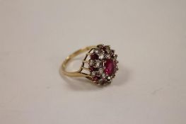 A 9ct gold dress ring set with pink gemstones. CONDITION REPORT: Good condition.