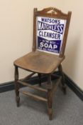 An early twentieth century kitchen chair with enamelled advertising panelled back 'Watson's