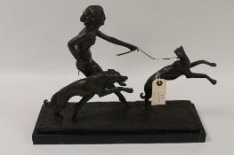 An Art Deco style bronze figure depicting a naked lady with two greyhounds, on black marble