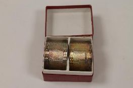 A pair of silver napkin rings, Birmingham 1922, cased.  CONDITION REPORT: Good gauge silver, not