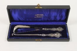 A silver mounted shoe horn and button pull, Chester 1904, cased. CONDITION REPORT: Excellent