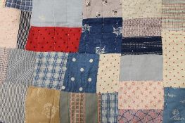 An early twentieth century hand stitched patchwork quilt. CONDITION REPORT: Fair with some faults.