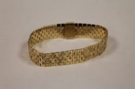 A 9ct textured gold flat-link bracelet, 42.7g. CONDITION REPORT: Good condition.