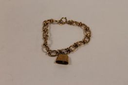 A 9ct gold bracelet, with cow-bell charm, 17.6g. CONDITION REPORT: Good condition.