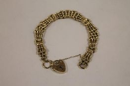 A 9ct gold fancy-link gate bracelet, 16.7g. CONDITION REPORT: Good condition.