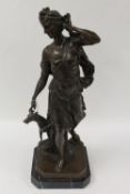 After Moreau - A bronze figure depicting a lady with dog, on black marble plinth, height 63 cm.