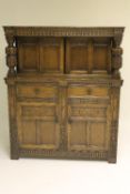 A carved oak buffet backed sideboard, width 121 cm. CONDITION REPORT: Good condition.