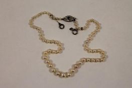 An early twentieth century graduated pearl necklace with diamond and sapphire clasp. CONDITION