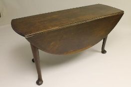 A George III drop leaf table on club legs, width 164 cm. CONDITION REPORT: Good condition, time aged