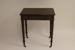 A Regency mahogany writing table, width 66 cm. CONDITION REPORT: On reeded legs with cappings and