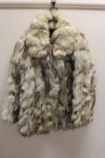 An early twentieth century fur jacket. CONDITION REPORT: Good.  Small split on collar.  Lining