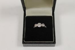 An 18ct white gold platinum set three-stone diamond ring. CONDITION REPORT: Good condition.