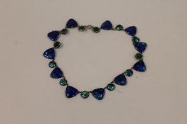 A white metal mounted blue iridescent glass necklace. CONDITION REPORT: Good condition, early