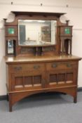 An oak arts and crafts mirror backed sideboard in the style of Liberty & Co, width 153 cm. CONDITION