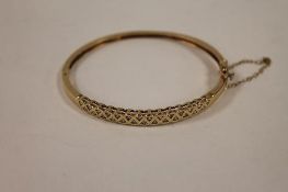 A 9ct gold bangle set with diamonds, 12.3g. CONDITION REPORT: Good condition.
