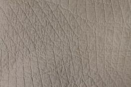 An early twentieth century hand stitched Durham quilt - white. CONDITION REPORT: Good.