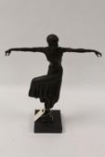 After Demetre H. Chiparus - A bronze figure depicting an Art Deco style dancer with her knee raised,