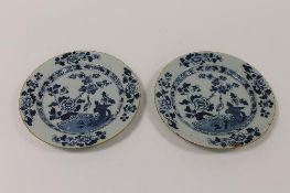 A pair of eighteenth century blue and white tin-glazed plates, diameter 22.5 cm. (2) CONDITION