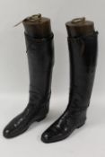 A pair of early twentieth century black leather Lady's riding boots, with wooden trees. (2)