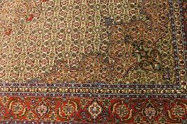 An Iranian fringed carpet, 198 cm x 296 cm. CONDITION REPORT: Good condition.