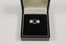 A platinum two-stone diamond and sapphire ring. CONDITION REPORT: Good condition.