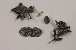 Two silver marcasite brooches, together with a dress ring and double clip brooch. (4) CONDITION