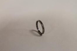 A diamond eternity ring. CONDITION REPORT: White metal shank unmarked. Condition fair.