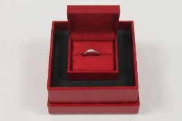 An 18ct white gold Canadian Ice three-stone diamond ring, with GGI report, documents and original