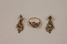A 9ct Welsh gold dress ring set with white topaz, together with the matching pair of earrings. (3)