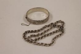 A silver bangle, together with a silver rope-twist necklace. (2) CONDITION REPORT: The bangle in