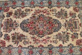 A small early twentieth century fringed Eastern rug, with floral borders, 151 cm x 89 cm.