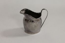 A Georgian silver cream jug, height 9 cm. CONDITION REPORT: Time-aged split and repair to the back