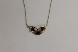 A white metal garnet pendant and chain, together with two fresh water pearl necklaces and a sterling