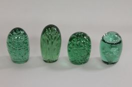 Four nineteenth century green glass dumps. (4) CONDITION REPORT: All with tiny nibbles and chips,