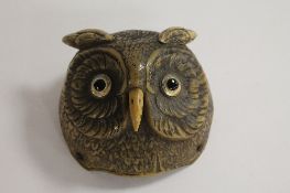 An early twentieth century desk bell modelled as an owl's head, with push action beak, width 9 cm.