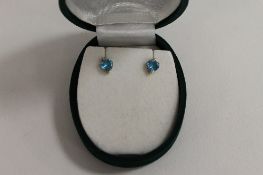A pair of 9ct gold diamond and topaz heart shaped earrings. (2)