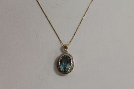 A 9ct gold diamond and topaz pendant on chain. CONDITION REPORT: Good condition, on plated chain,