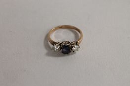 An 18ct gold two stone diamond and sapphire ring. CONDITION REPORT: The two diamonds approximatley