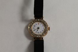 A 9ct gold diamond cocktail watch, the enamel dial encrusted with twenty-eight diamonds. CONDITION