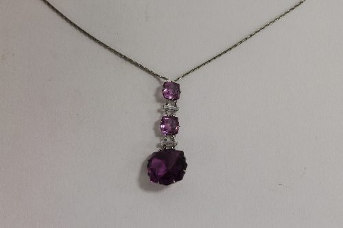 A platinon amethyst drop necklace.