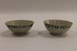 A pair of Tek Sing Chinese blue and white rice bowls, width 11 cm. CONDITION REPORT: Good condition,