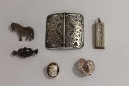 A silver belt buckle, Birmingham 1910, together with three silver brooches, a silver ingot and a 9ct