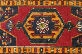 A small early twentieth century fringed Eastern rug, 127 cm x 72 cm. CONDITION REPORT: Good