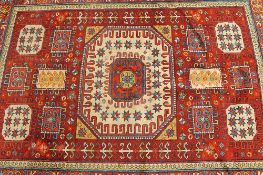 An early twentieth century fringed Eastern rug, with multi-colour decoration, 126 cm x 172 cm.