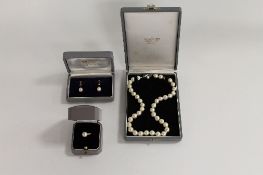 A 14ct gold pearl ring, together with the matching pair of 14ct gold pearl earrings and pearl
